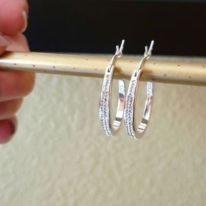 Silver tone hoop earrings with CZs